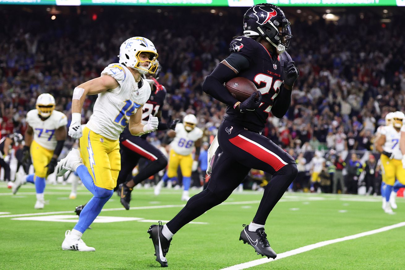 Eric Murray #23 of the Houston Texans returns an interception for a touchdown against the Los Angeles Chargers in the third quarter during the AFC Wild Card Playoffs at NRG Stadium on January 11, 2025 in Houston, Texas.
