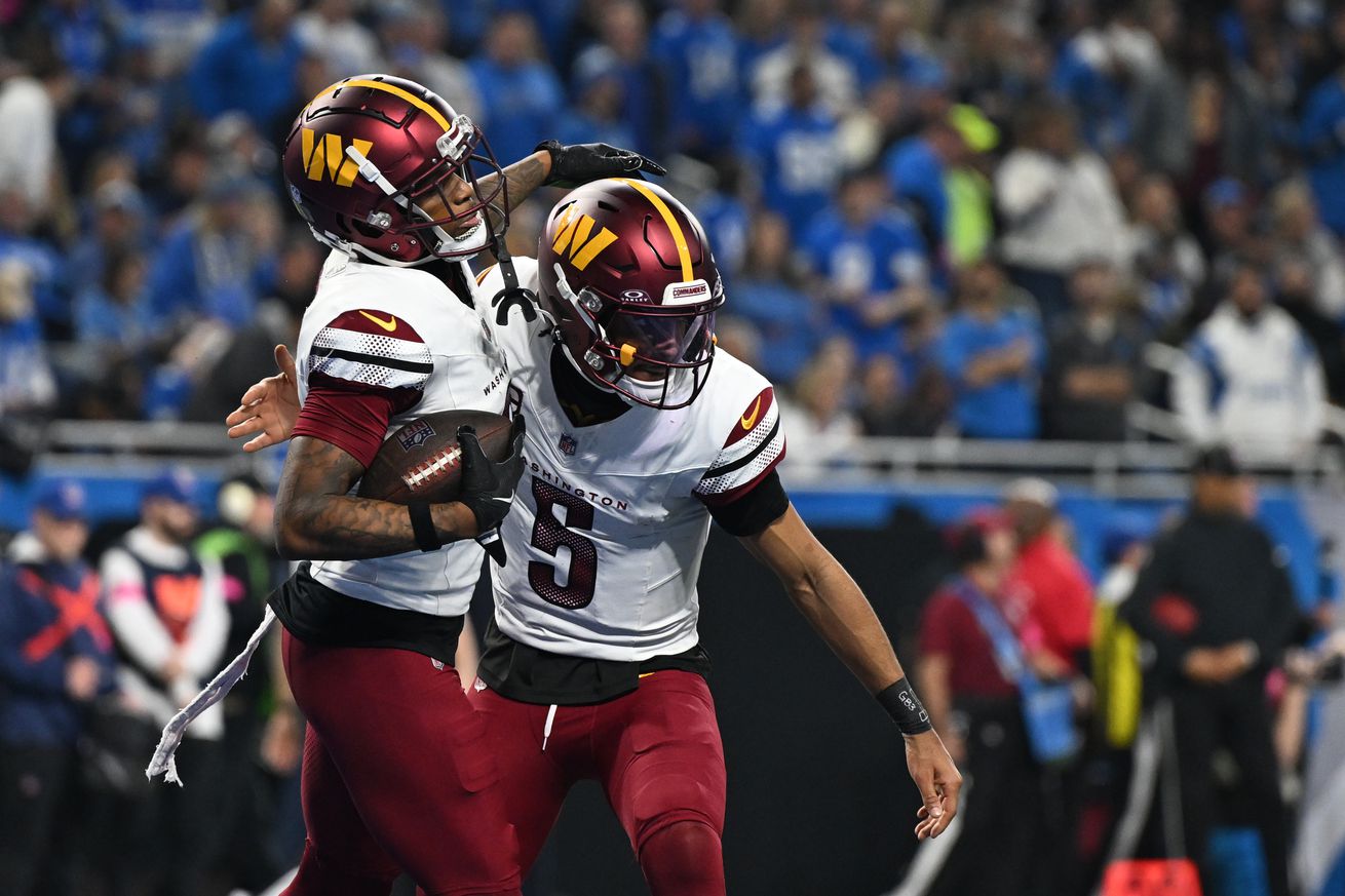 Washington Commanders tight end Zach Ertz (86) celebrates touchdown pass with quarterback Jayden Daniels (5) during the second quarter in a 2025 NFC divisional round game at Ford Field.
