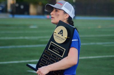 Marymount’s Carly Rivera holds the trophy after winning the Atlantic East Championship for women’s flag football on Saturday, April 26, 2025, in Arlington, Va.